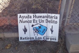 “Humanitarian aid is never a crime. Drop the charges.” sign in Tucson, AZ.