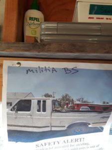 Militia/vigilante caution sign posted in the medical trailer.