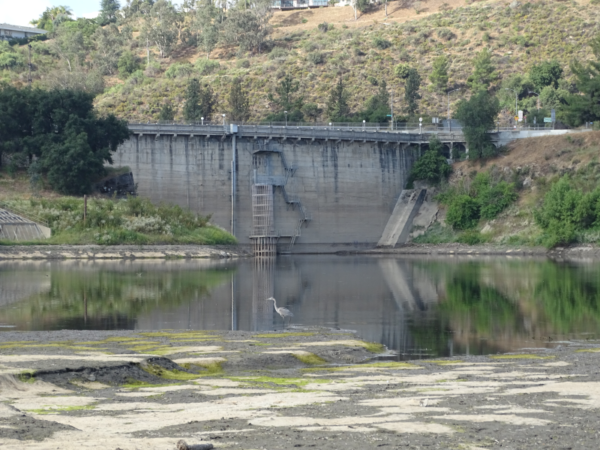 A view of the dam from the reservoir side. The water level is low.