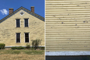 Left image: Side of a symmetrical yellow house with peeling paint with four rectangular windows in the center of the facade with one diamond shaped window above, along with two chimneys on the roof. It is situated among dying grass and a blue sky. Right: Closeup of yellow paint peeling on the housing’s siding.