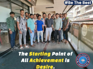 The image is an advertisement for a mobile training institute located in the main bus station of Ahmedabad. It shows young men who have joined the training institute with an aspiration of setting up their own mobile repair businesses. 