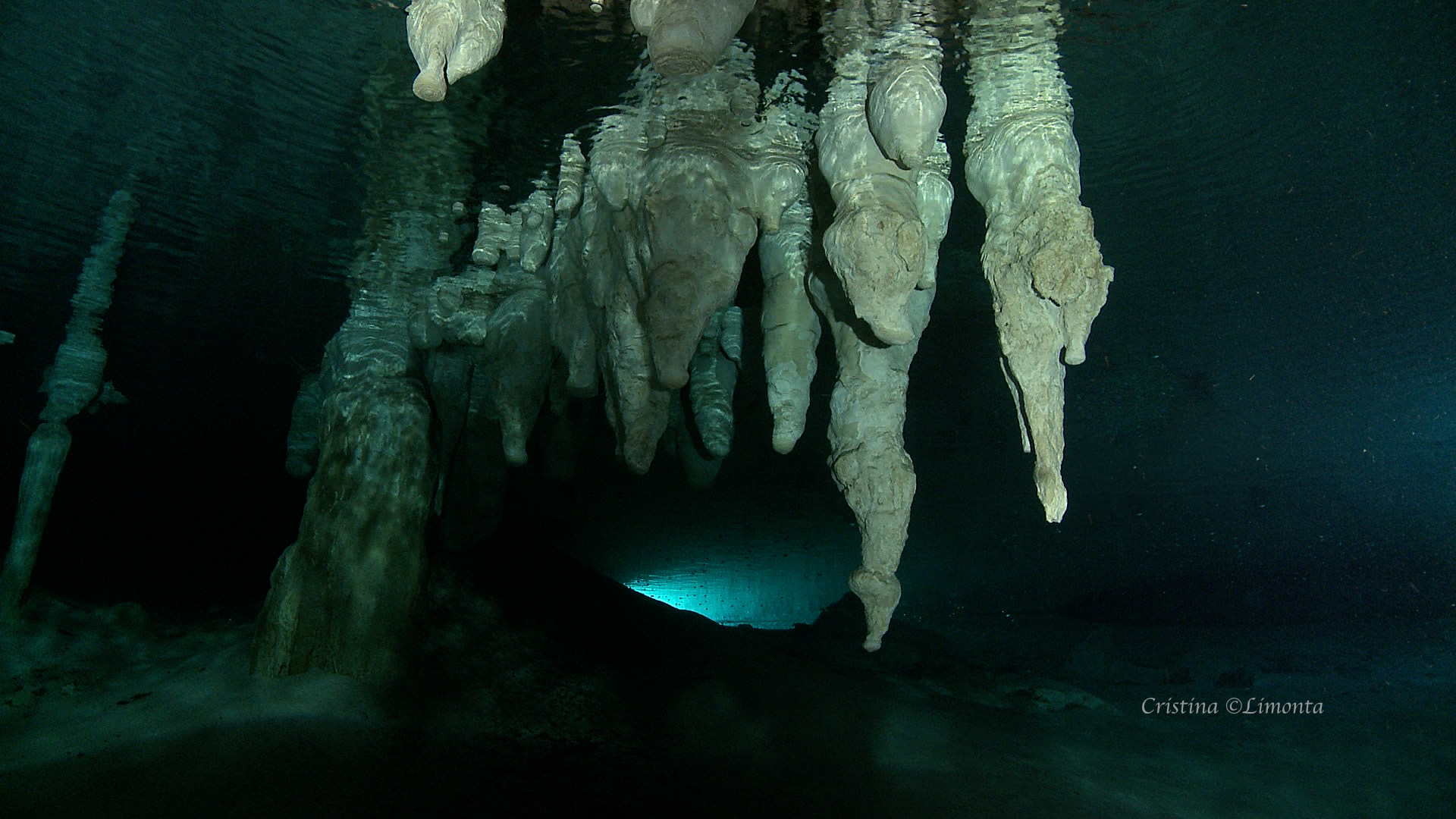 Cave formations seen from below the water level in a submerged cave.