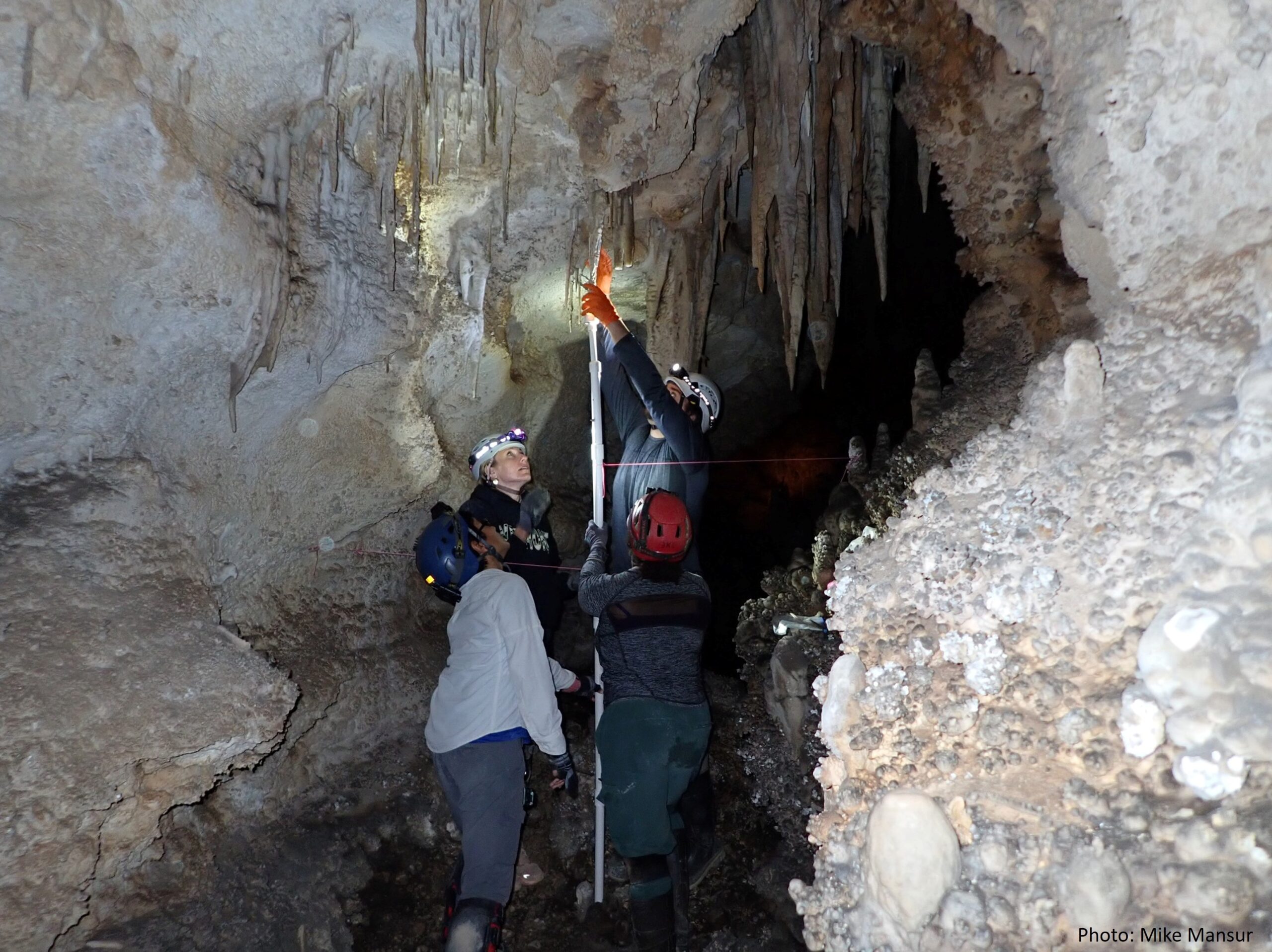 two people work together in the installation of a Stalacktijack to hold a recently fixed broken stalactite