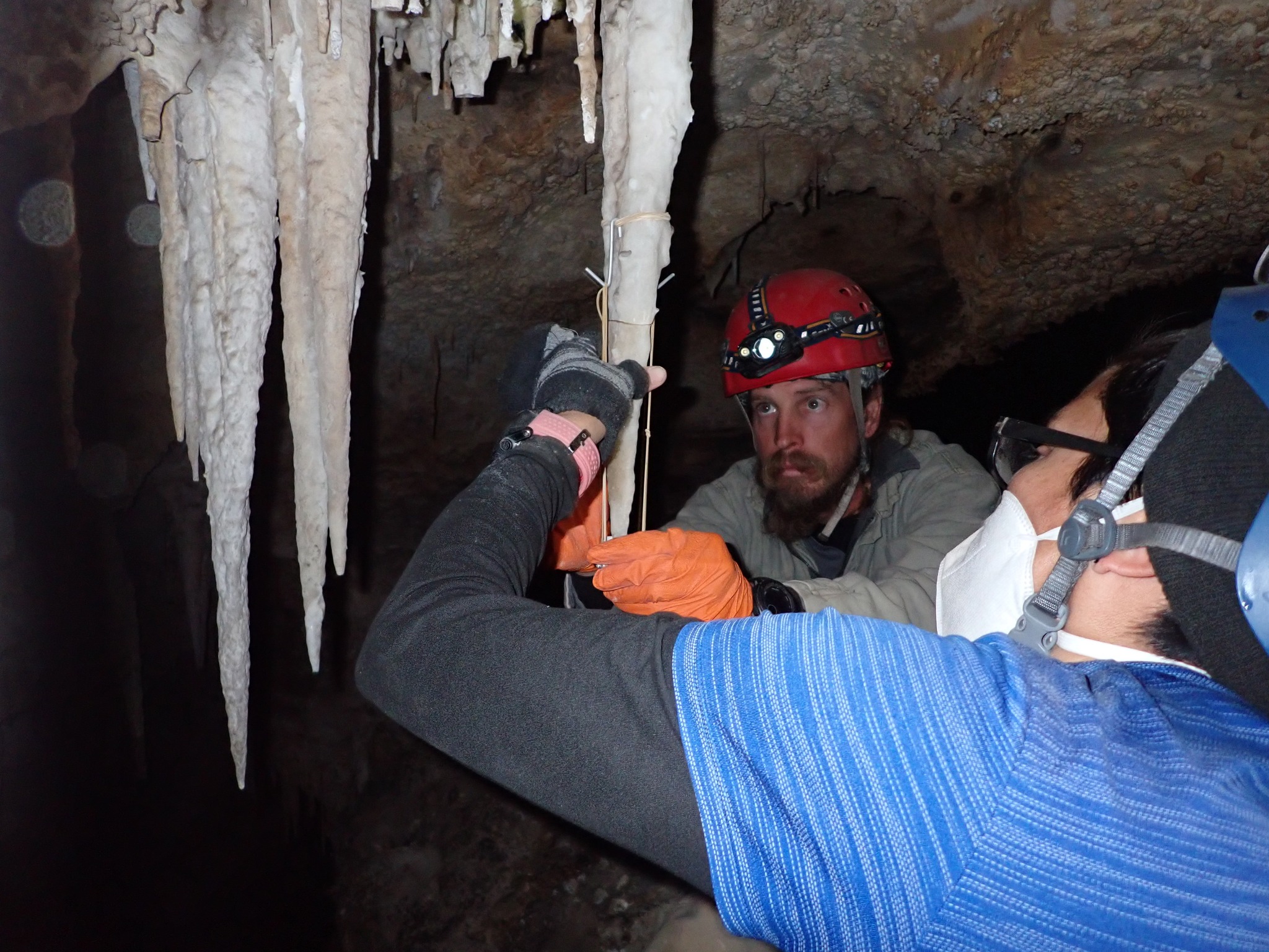 two people work together in the installation of a Stalacktijack to hold a recently fixed broken stalactite